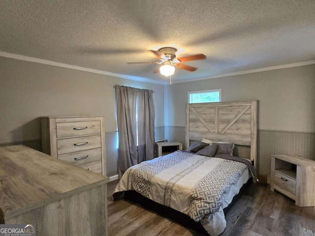 50 E College St, Royston, GA 30662 - bedroom with crown molding, a textured ceiling, dark wood finished floors, a wainscoted wall, and ceiling fan