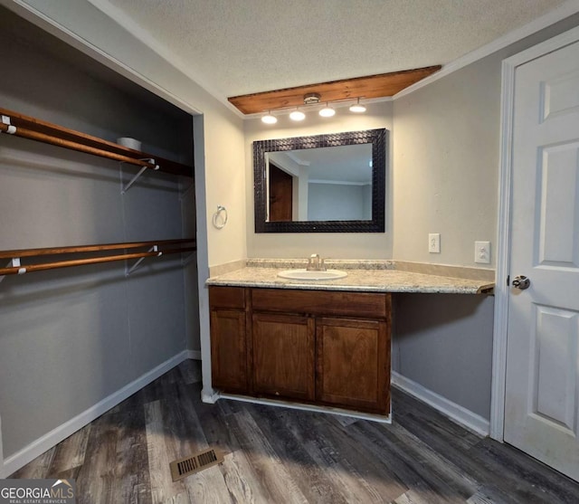 50 E College St, Royston, GA 30662 - bathroom featuring vanity, wood finished floors, and a textured ceiling