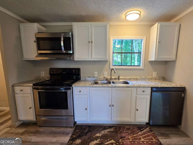 50 E College St, Royston, GA 30662 - kitchen featuring appliances with stainless steel finishes, dark wood-style flooring, white cabinetry, and a textured ceiling