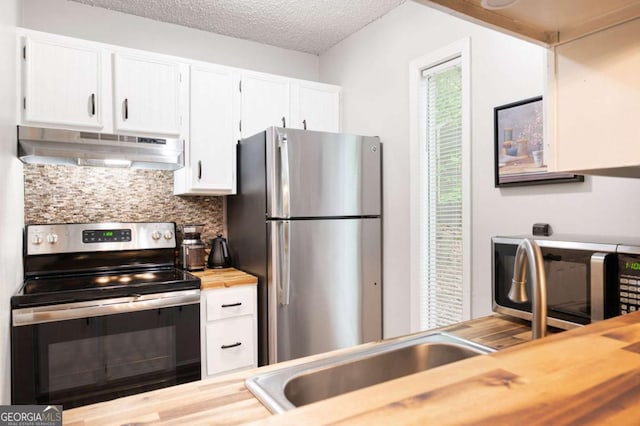 140 Indian Ridge Ct, Waleska, GA 30183 - kitchen featuring stainless steel appliances, under cabinet range hood, wood counters, backsplash, and white cabinets