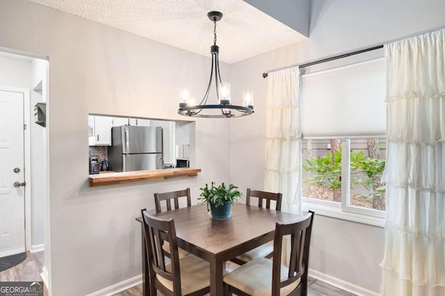 140 Indian Ridge Ct, Waleska, GA 30183 - dining area with a chandelier and wood finished floors