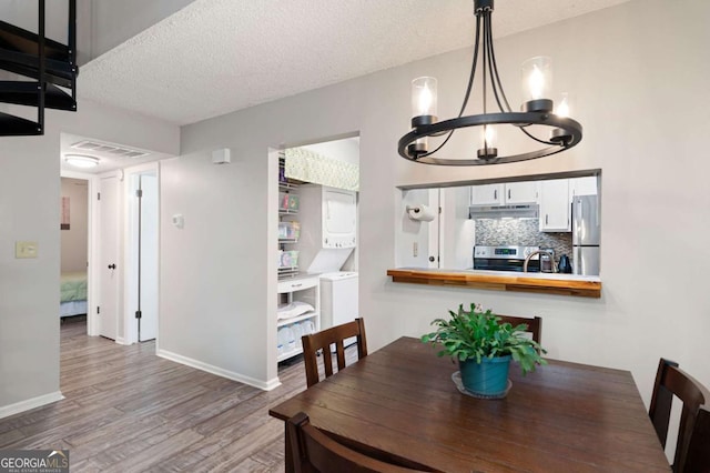 140 Indian Ridge Ct, Waleska, GA 30183 - dining space featuring a chandelier, wood finished floors, and a textured ceiling