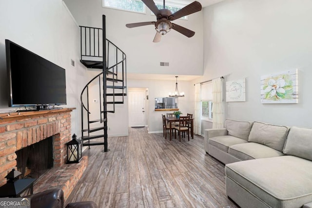 140 Indian Ridge Ct, Waleska, GA 30183 - living area with a towering ceiling, stairs, ceiling fan, wood finished floors, and a chandelier