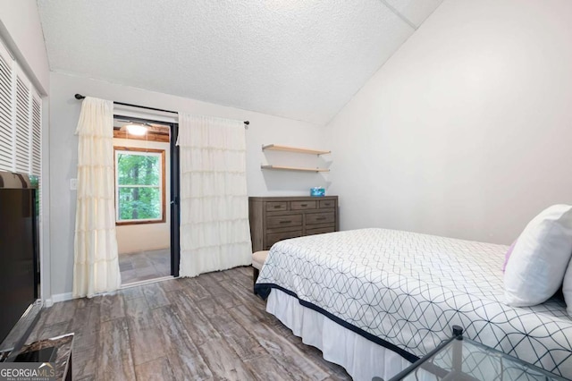 140 Indian Ridge Ct, Waleska, GA 30183 - bedroom featuring wood finished floors, lofted ceiling, and a textured ceiling