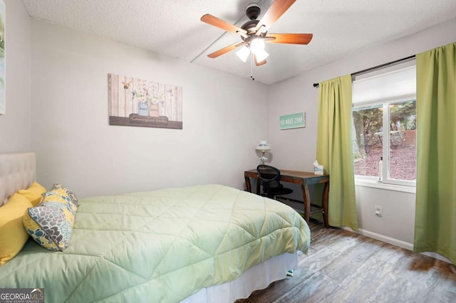 140 Indian Ridge Ct, Waleska, GA 30183 - bedroom featuring wood finished floors, a textured ceiling, and ceiling fan