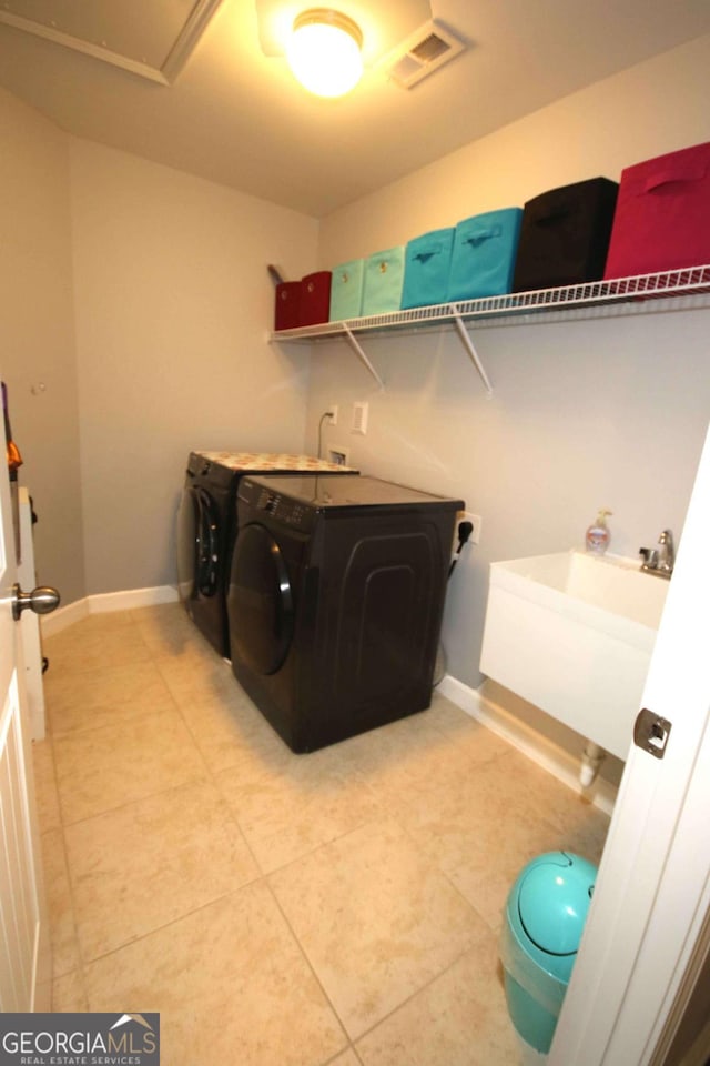2311 Arnold Palmer Way, Duluth, GA 30096 - washroom featuring washing machine and dryer and light tile patterned flooring
