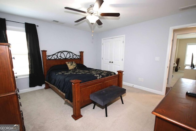 2311 Arnold Palmer Way, Duluth, GA 30096 - bedroom with light colored carpet, a closet, and a ceiling fan