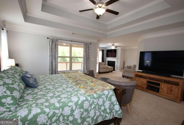 2311 Arnold Palmer Way, Duluth, GA 30096 - carpeted bedroom featuring a tray ceiling, a fireplace, crown molding, and ceiling fan