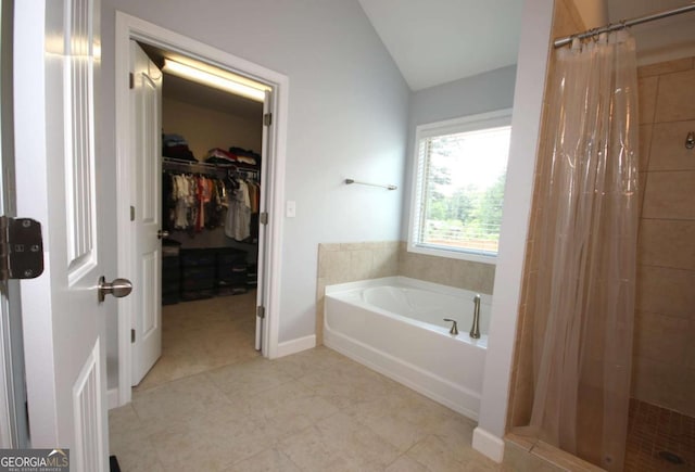 2311 Arnold Palmer Way, Duluth, GA 30096 - bathroom with a stall shower, a bath, lofted ceiling, a spacious closet, and tile patterned flooring