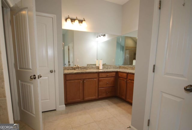 2311 Arnold Palmer Way, Duluth, GA 30096 - bathroom featuring double vanity, tile patterned flooring, and a shower