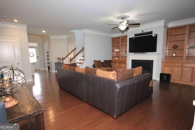 2311 Arnold Palmer Way, Duluth, GA 30096 - living room featuring ornamental molding, a ceiling fan, dark wood finished floors, a fireplace, and stairway