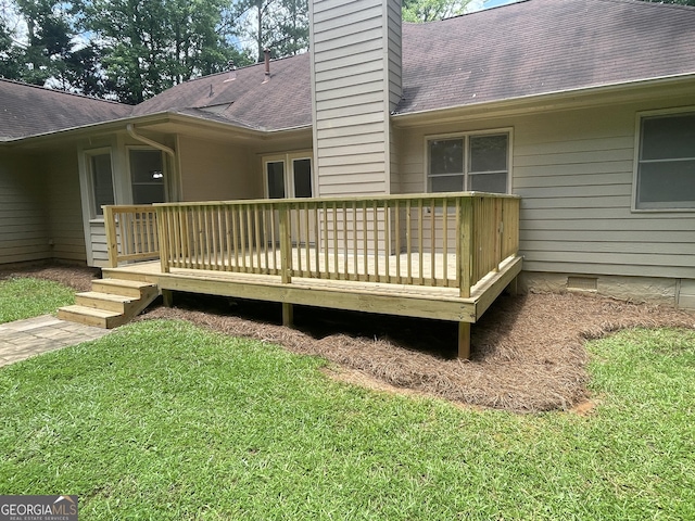 56 Ridgewood Ct, Mcdonough, GA 30252 - back of house with a chimney, roof with shingles, a lawn, and a deck
