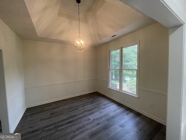 56 Ridgewood Ct, Mcdonough, GA 30252 - empty room featuring a raised ceiling, dark wood finished floors, and a chandelier