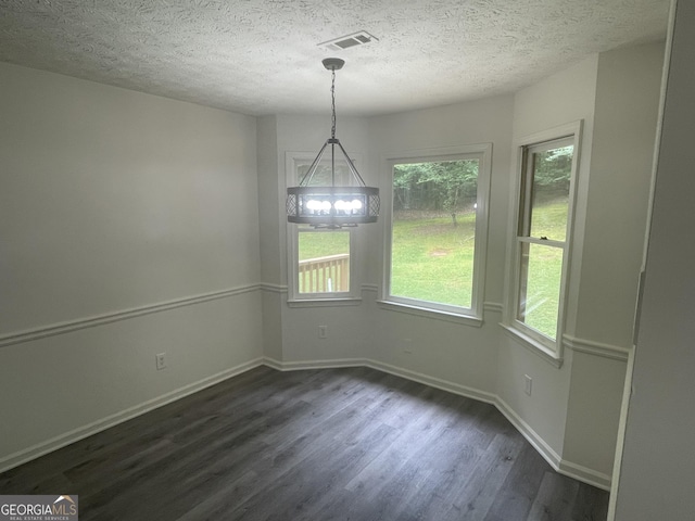 56 Ridgewood Ct, Mcdonough, GA 30252 - unfurnished dining area featuring dark wood-style flooring, plenty of natural light, and a textured ceiling