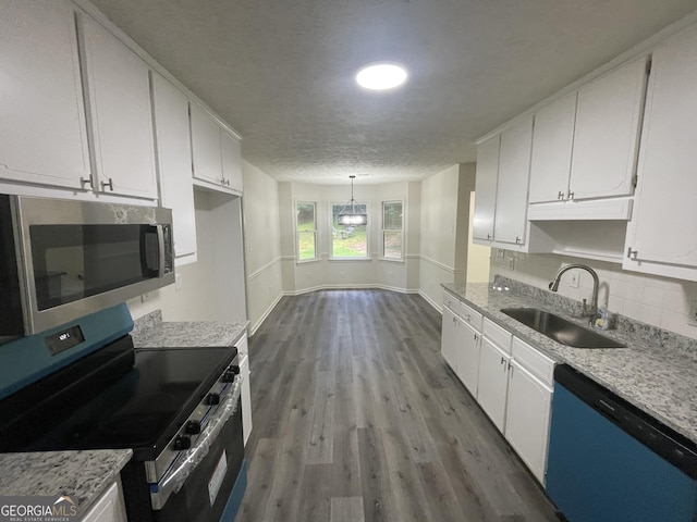 56 Ridgewood Ct, Mcdonough, GA 30252 - kitchen with appliances with stainless steel finishes, dark wood-style flooring, white cabinetry, tasteful backsplash, and a textured ceiling
