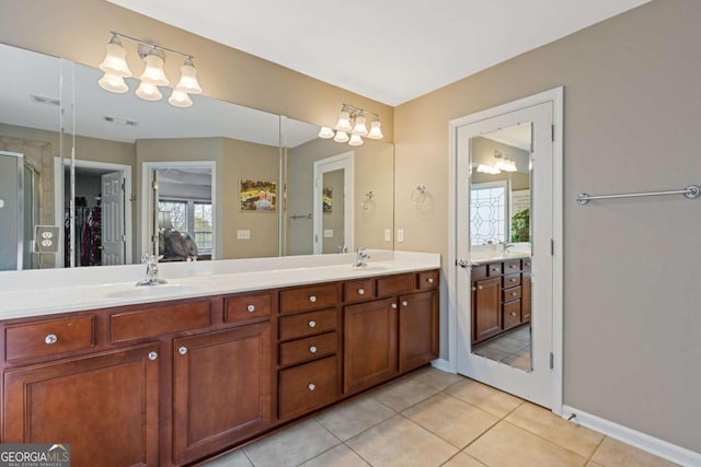 610 Syemore Pass, Canton, GA 30115 - bathroom with double vanity, tile patterned flooring, a chandelier, a shower stall, and a spacious closet