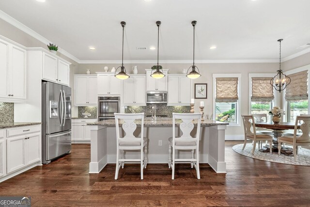 406 Horizon Trl, Canton, GA 30114 - kitchen with appliances with stainless steel finishes, dark wood-style flooring, white cabinets, decorative backsplash, and a kitchen island with sink