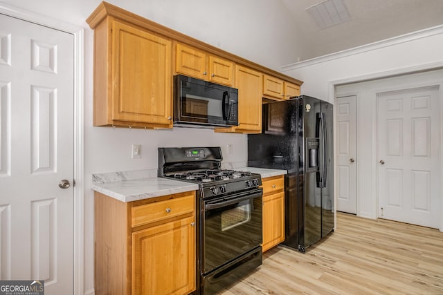 14 Winter Ln, Newnan, GA 30265 - kitchen with black appliances, light countertops, light wood-type flooring, and lofted ceiling