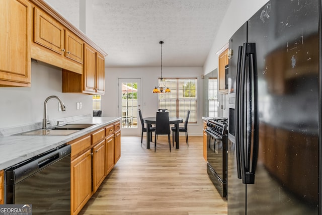 14 Winter Ln, Newnan, GA 30265 - kitchen with black appliances, light wood finished floors, a textured ceiling, light countertops, and hanging light fixtures