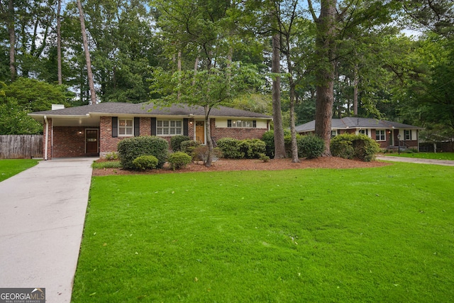 2790 Laurel Ridge Dr, Decatur, GA 30033 - ranch-style home featuring concrete driveway, brick siding, a carport, a chimney, and view of scattered trees