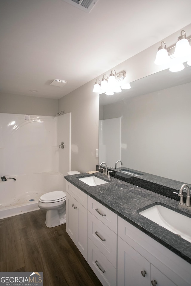 331 Red Berry Rd, Jackson, GA 30233 - bathroom featuring double vanity, wood finished floors, and a shower