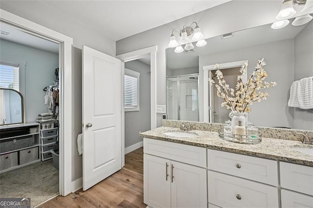 5 Towne Villas Dr, Jasper, GA 30143 - bathroom featuring double vanity, a shower stall, wood finished floors, and a spacious closet