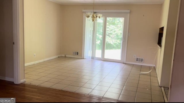 6521 Menlo Way, Rex, GA 30273 - tiled empty room featuring a chandelier and baseboards