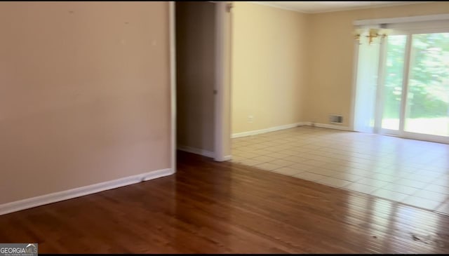 6521 Menlo Way, Rex, GA 30273 - unfurnished room with plenty of natural light, wood finished floors, and ornamental molding