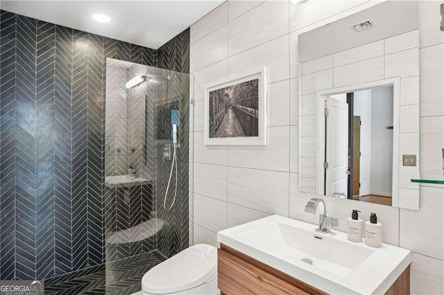 943 Peachtree St NE Unit 902, Atlanta, GA 30309 - bathroom featuring tile walls, vanity, and a tile shower