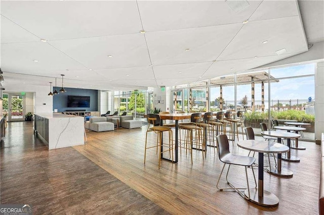 943 Peachtree St NE Unit 902, Atlanta, GA 30309 - dining area featuring a wall of windows and wood finished floors