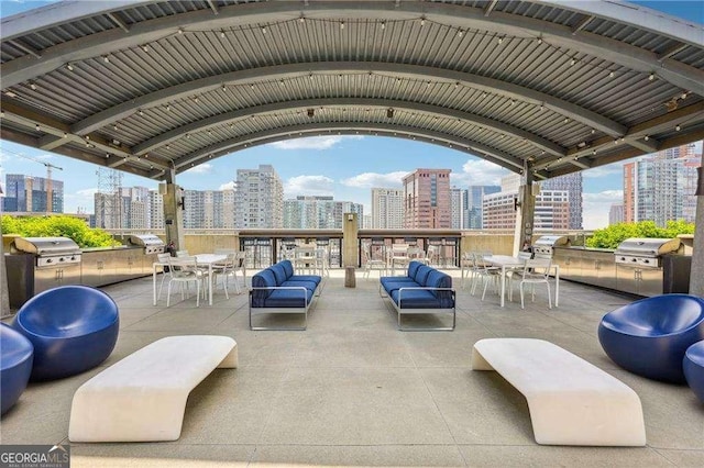 943 Peachtree St NE Unit 902, Atlanta, GA 30309 - view of patio featuring a skyline view, area for grilling, and outdoor dining area