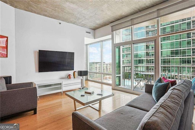 943 Peachtree St NE Unit 902, Atlanta, GA 30309 - living room with wood finished floors and floor to ceiling windows