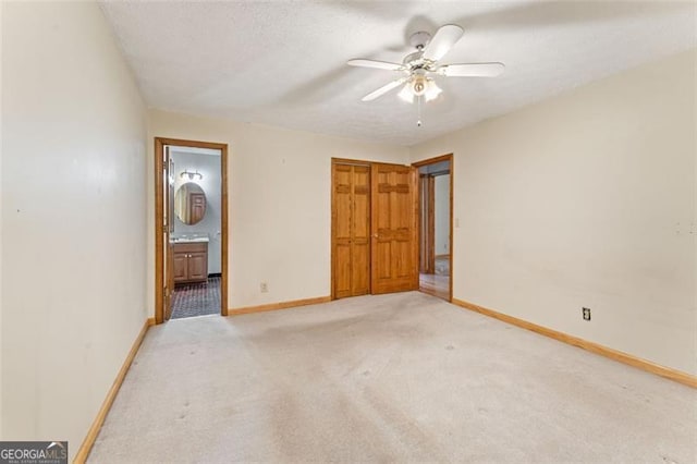 137 Trickum Hills Dr, Woodstock, GA 30188 - unfurnished bedroom featuring light carpet, connected bathroom, a closet, and a ceiling fan