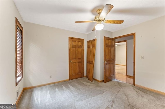 137 Trickum Hills Dr, Woodstock, GA 30188 - unfurnished bedroom with light carpet, ceiling fan, and a closet