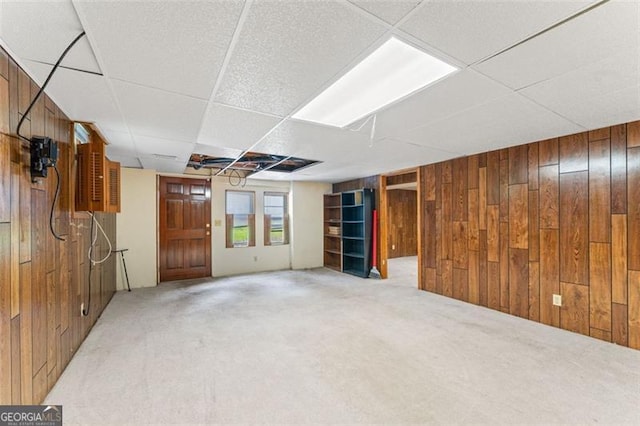137 Trickum Hills Dr, Woodstock, GA 30188 - below grade area with wood walls, light colored carpet, and a paneled ceiling