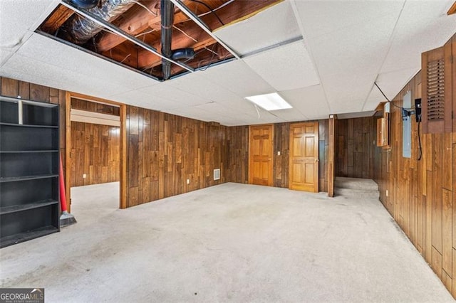 137 Trickum Hills Dr, Woodstock, GA 30188 - basement featuring wooden walls, carpet flooring, and a drop ceiling