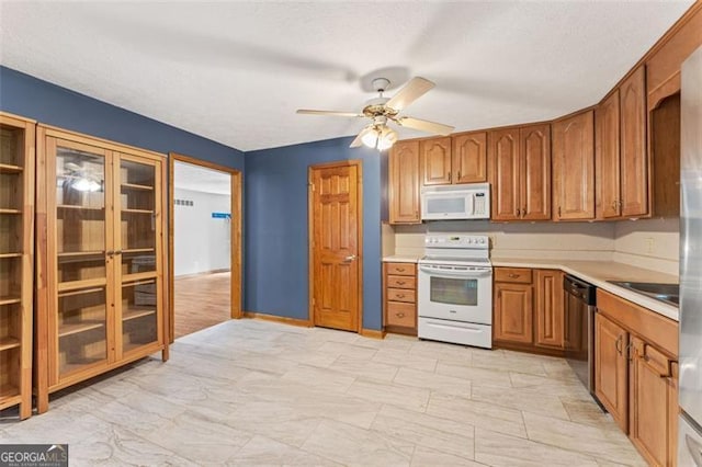 137 Trickum Hills Dr, Woodstock, GA 30188 - kitchen with white appliances, light countertops, brown cabinetry, and a ceiling fan