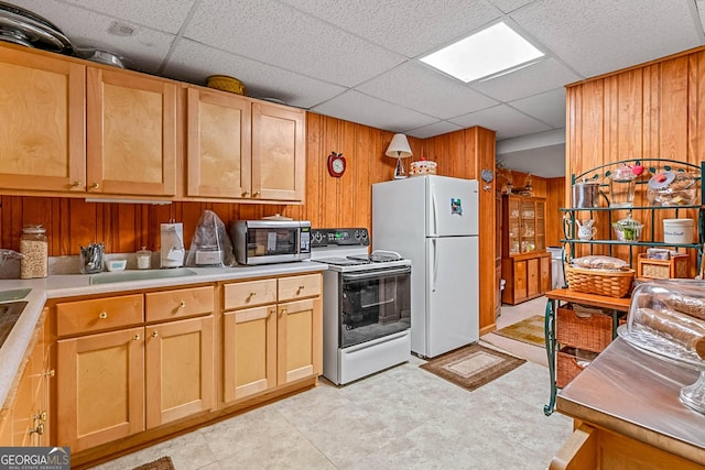 1813 Freeman Rd, Jonesboro, GA 30236 - kitchen featuring range with electric cooktop, stainless steel microwave, freestanding refrigerator, wooden walls, and a paneled ceiling