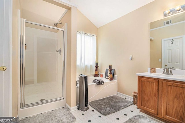 2437 Charleston Pointe Ct SE, Atlanta, GA 30316 - bathroom featuring a shower stall, vaulted ceiling, a bath, vanity, and tile patterned flooring