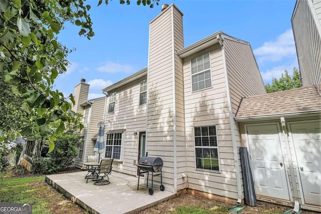 2437 Charleston Pointe Ct SE, Atlanta, GA 30316 - back of property featuring a chimney and a patio area