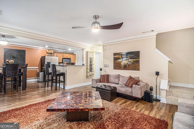 2437 Charleston Pointe Ct SE, Atlanta, GA 30316 - living area featuring wood finished floors, ornamental molding, and a ceiling fan