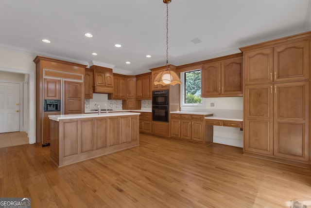 821 Carnellian Ln, Peachtree City, GA 30269 - kitchen featuring paneled built in refrigerator, light wood finished floors, light countertops, ornamental molding, and backsplash
