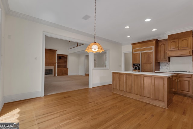 821 Carnellian Ln, Peachtree City, GA 30269 - kitchen featuring light countertops, recessed lighting, crown molding, an island with sink, and hanging light fixtures
