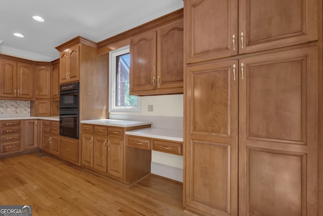 821 Carnellian Ln, Peachtree City, GA 30269 - kitchen featuring light wood-type flooring, light countertops, brown cabinets, recessed lighting, and ornamental molding