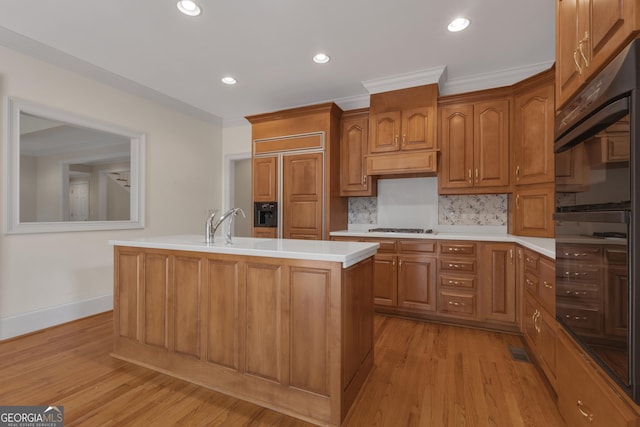 821 Carnellian Ln, Peachtree City, GA 30269 - kitchen with light countertops, decorative backsplash, light wood-type flooring, gas cooktop, and crown molding