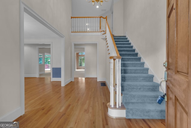821 Carnellian Ln, Peachtree City, GA 30269 - entryway featuring stairway, wood finished floors, a high ceiling, and a chandelier