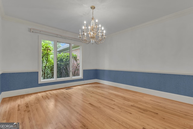 821 Carnellian Ln, Peachtree City, GA 30269 - unfurnished room featuring crown molding, wood finished floors, and a chandelier
