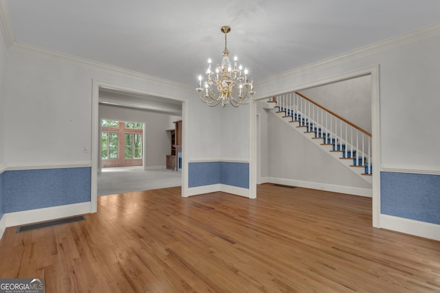 821 Carnellian Ln, Peachtree City, GA 30269 - empty room featuring ornamental molding, wood finished floors, a chandelier, and stairs