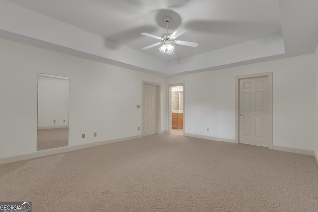 821 Carnellian Ln, Peachtree City, GA 30269 - empty room featuring a ceiling fan, light colored carpet, and a tray ceiling