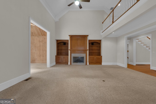 821 Carnellian Ln, Peachtree City, GA 30269 - unfurnished living room featuring high vaulted ceiling, carpet flooring, a ceiling fan, stairway, and a fireplace